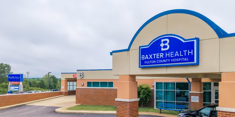 Exterior view of Fulton County Hospital with Baxter Health sign on the front.