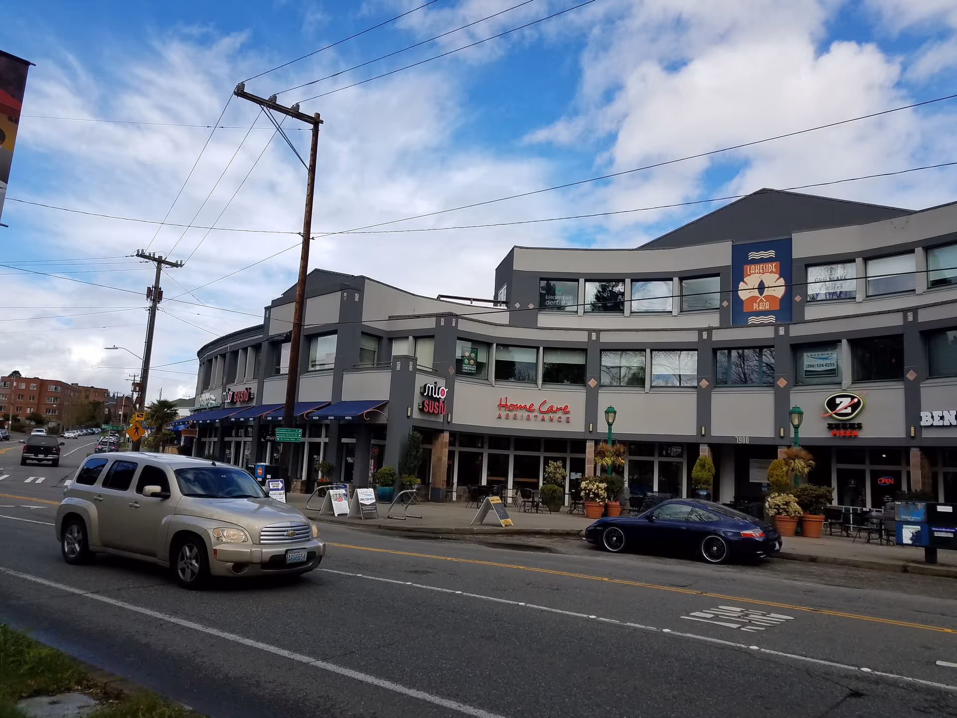 Exterior view of a modern building with storefronts and a 'Home Care' sign