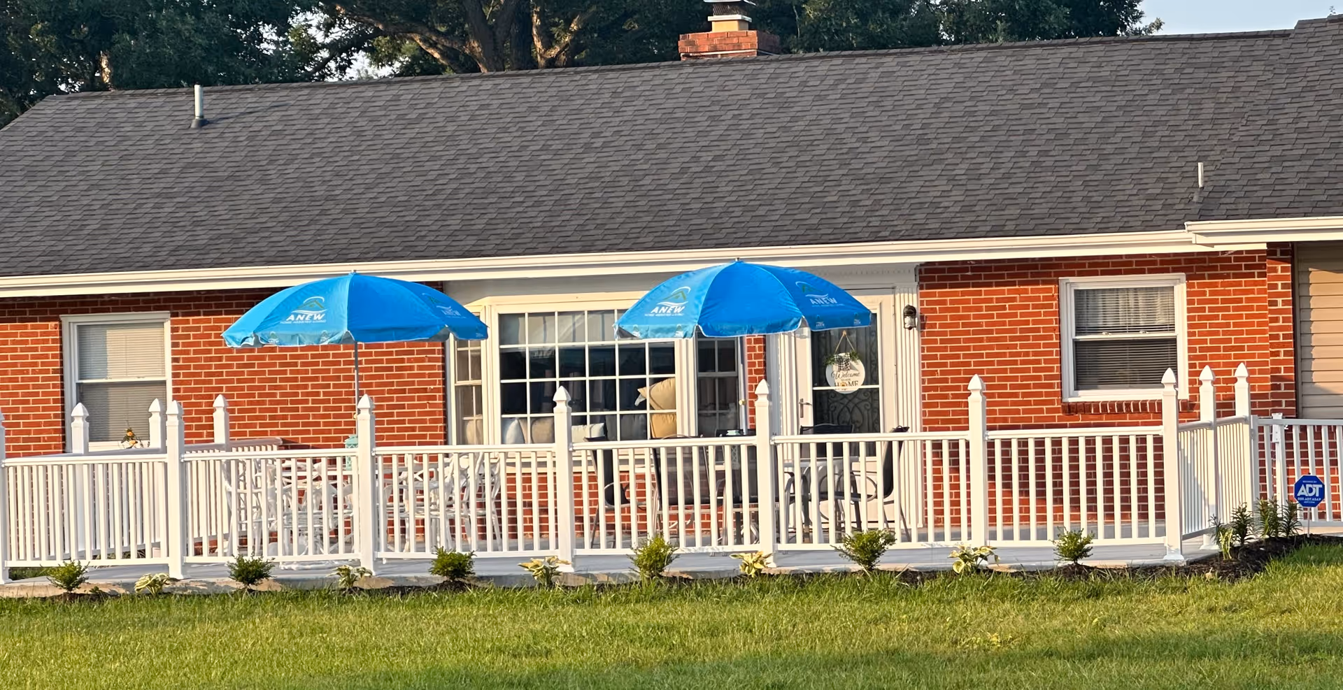 Anew Home Assisted Living exterior with deck and blue umbrellas.