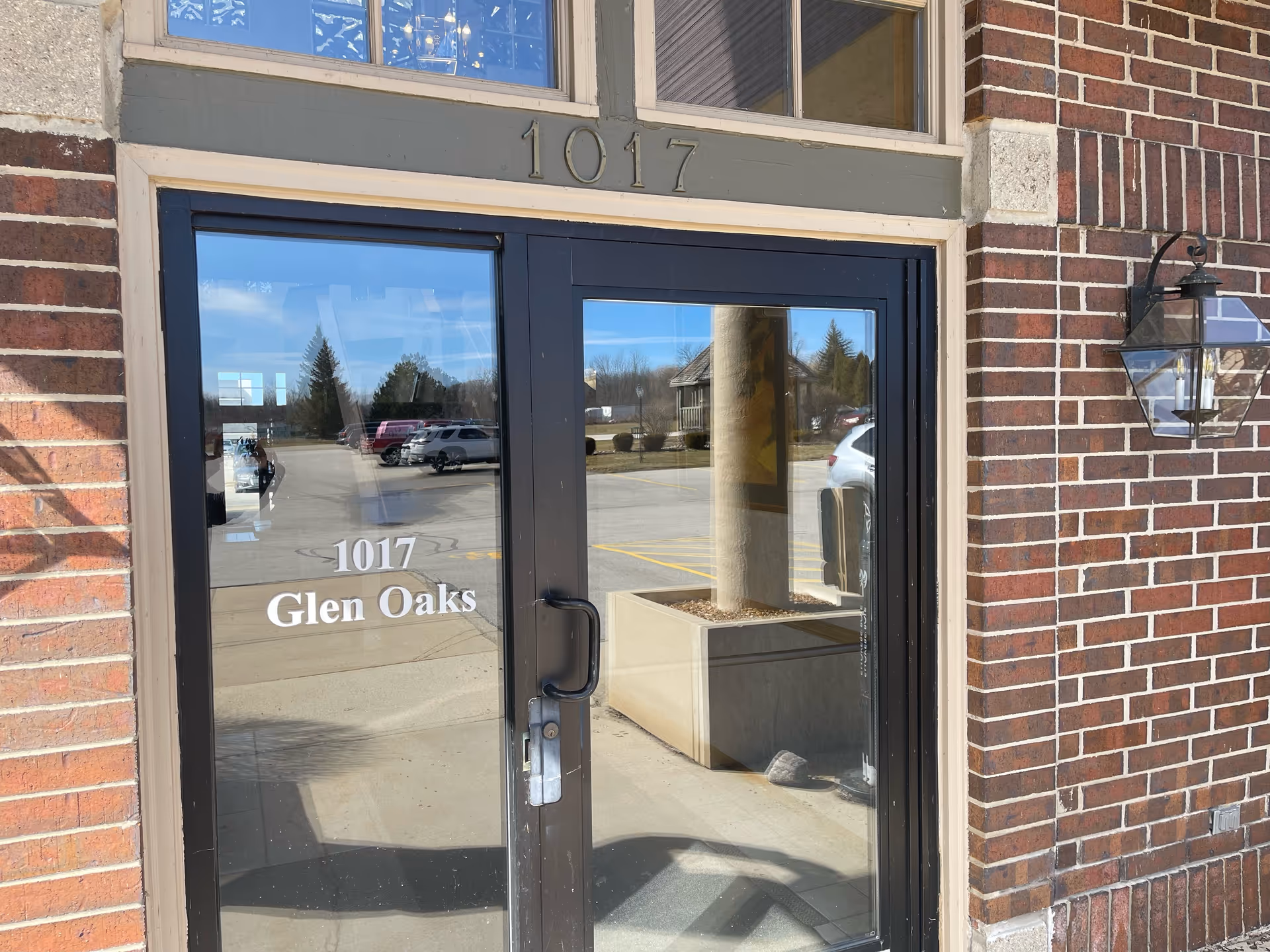 Brick building exterior with glass door entrance showing 1017 Glen Oaks.