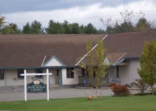 Exterior view of a single-story facility with a sign reading Addison County Home Health & Hospice.