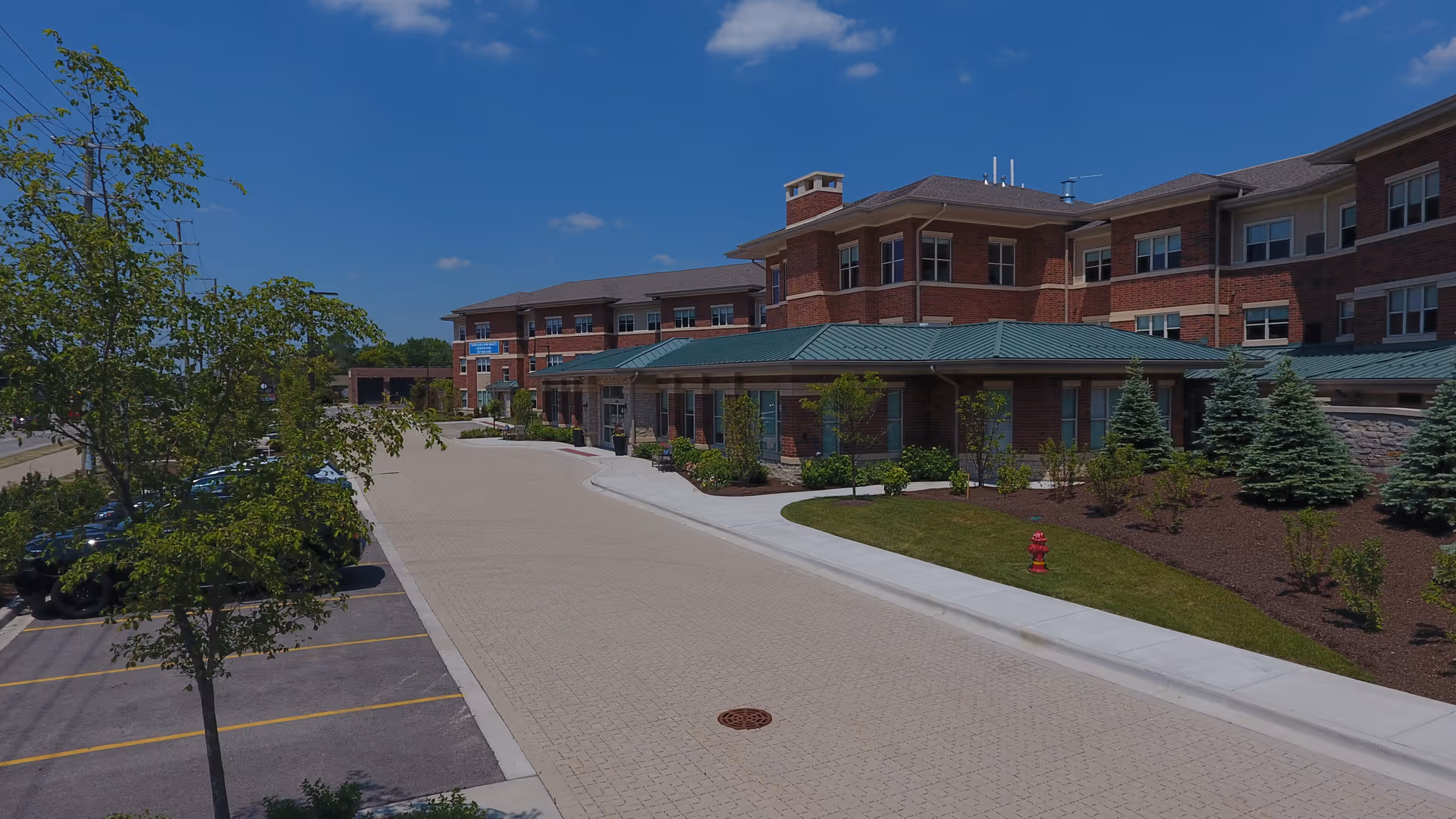 Exterior view of The Landing on Dundee Senior Living building with entrance and landscaped grounds.