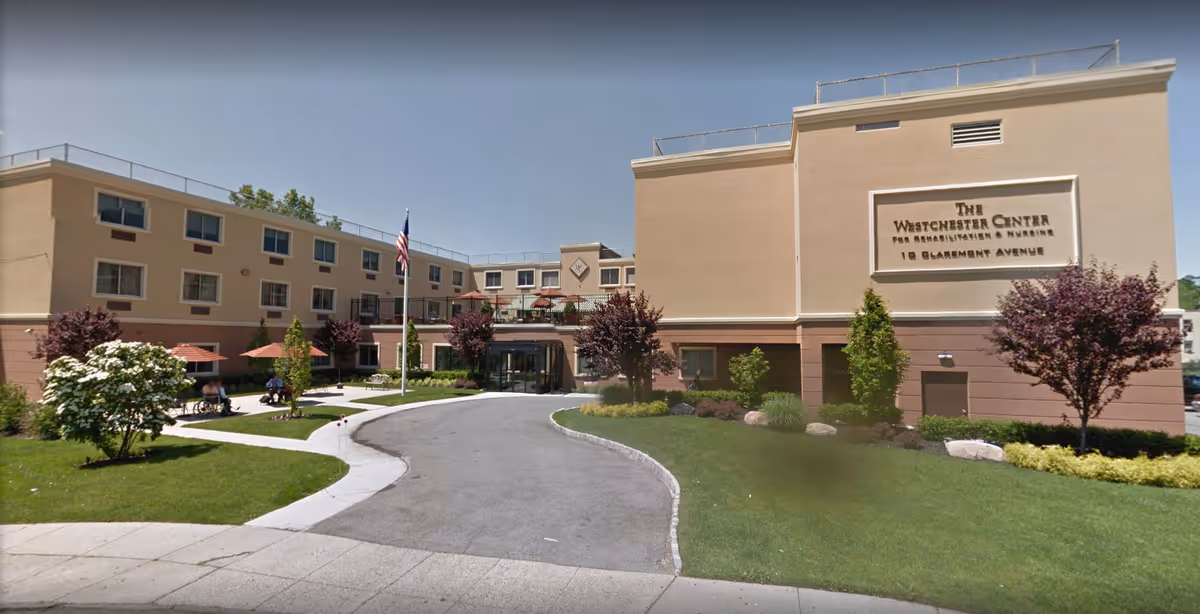 Exterior view of Westchester Center for Rehabilitation and Nursing with landscaping and entrance.