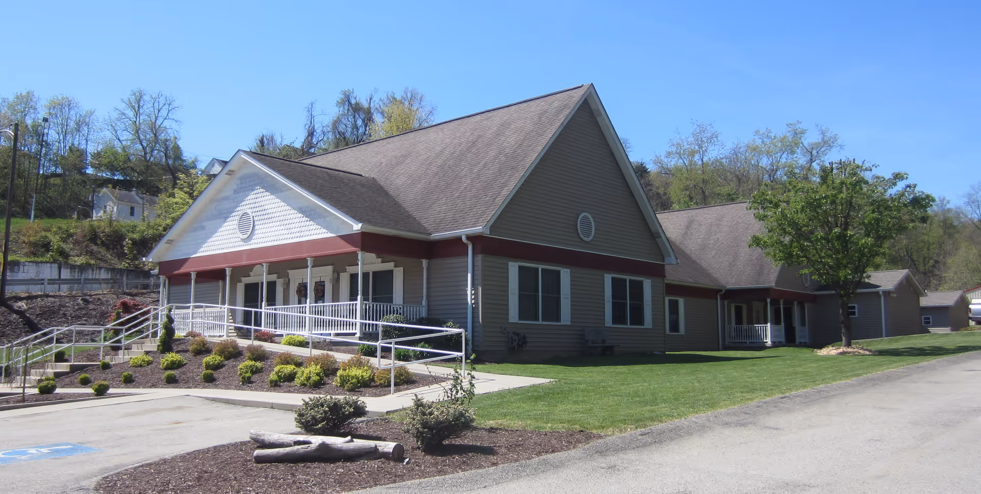 Exterior of Aster Assisted Living of Clintonville, a single-story building with front entrance and manicured grounds.