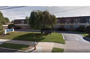 Exterior view of Liberty Center for Rehabilitation and Nursing, with lawn and driveway