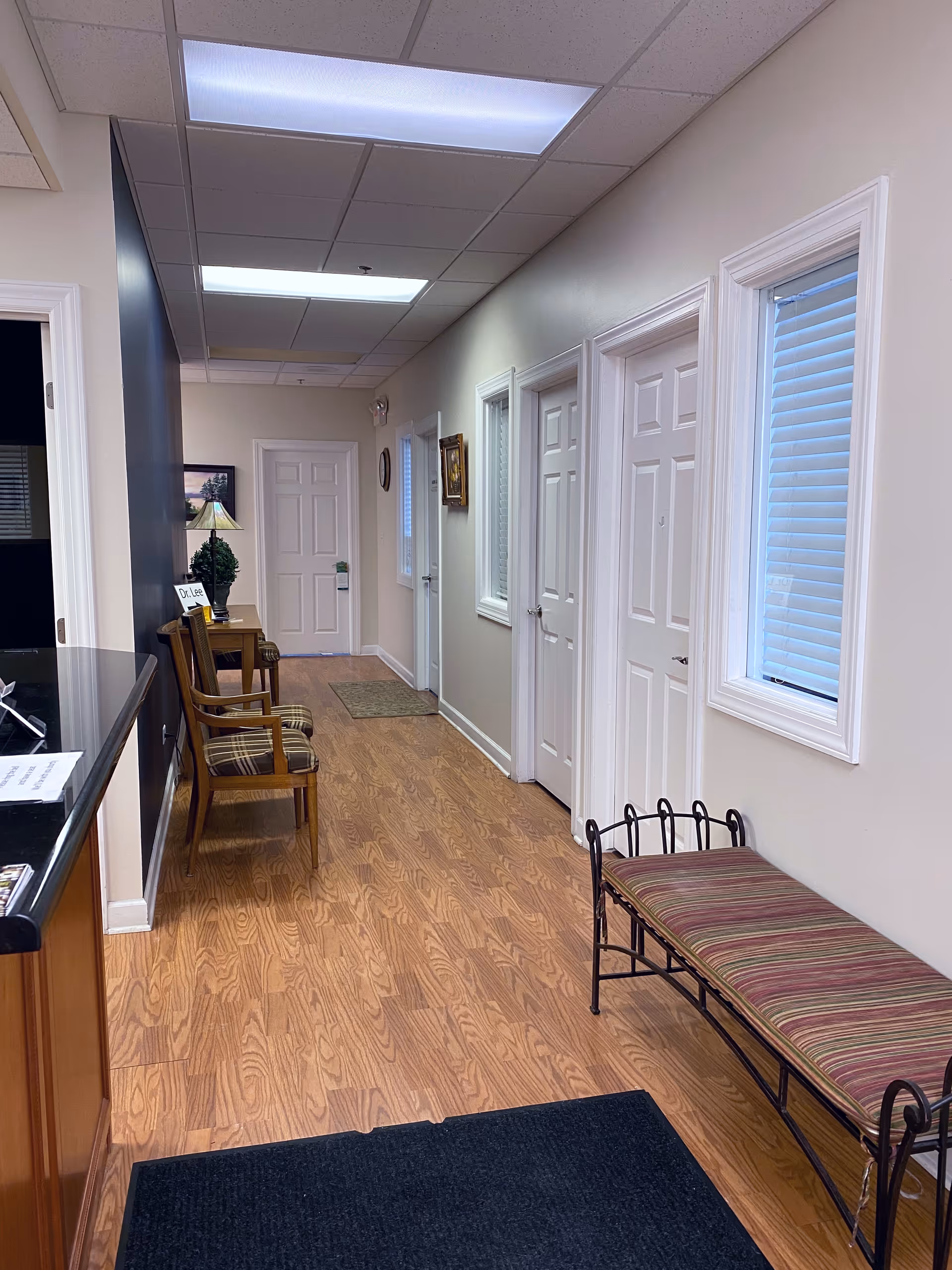 Interior corridor of Gentle Touch Home Assist with doors, seating, and windows.