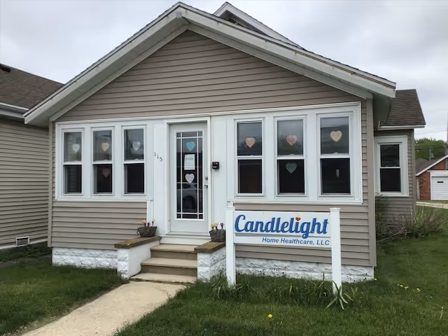 Front view of Candlelight Home Healthcare, LLC building with heart-decorated windows and sign.