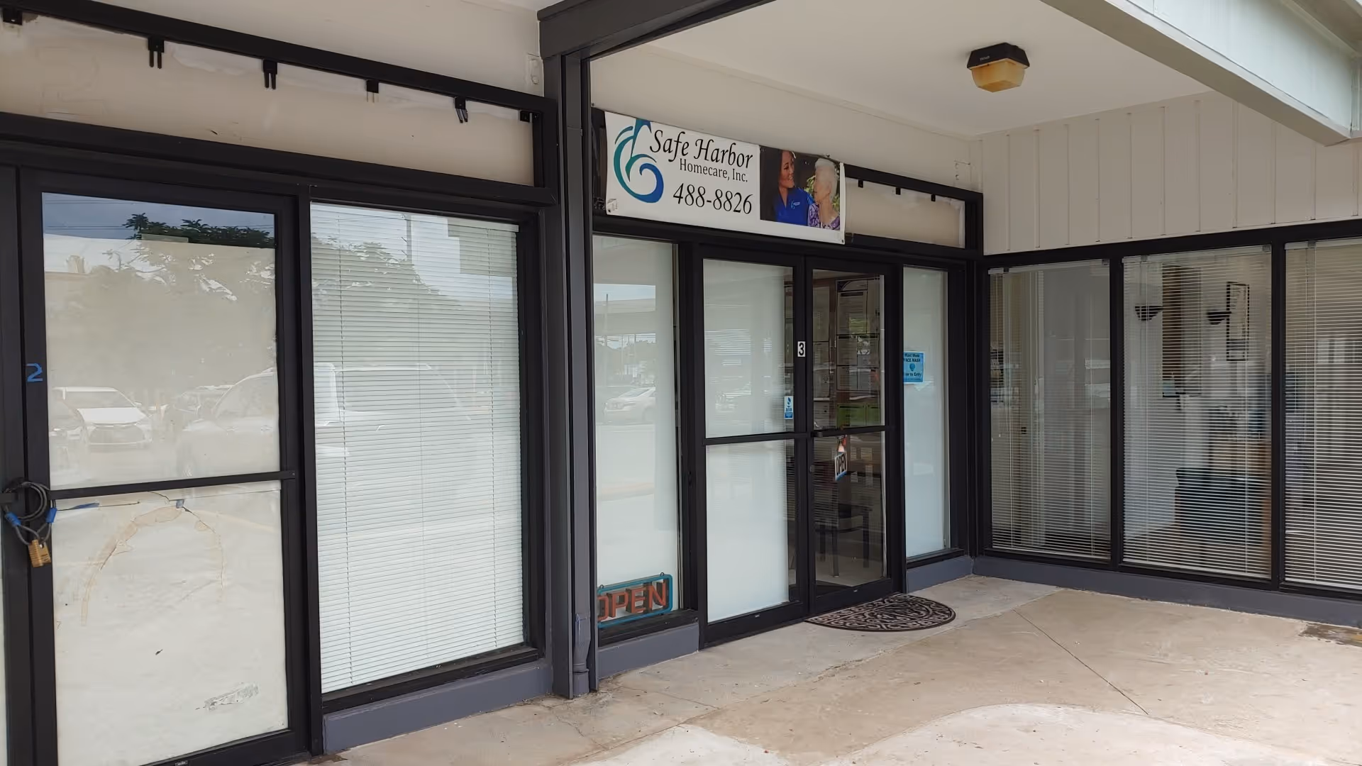 Exterior view of Safe Harbor Homecare storefront with glass doors and windows.