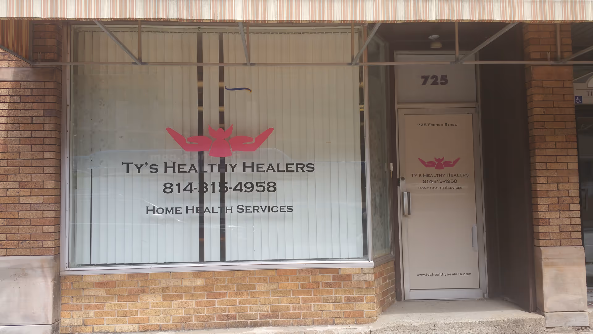 Brick storefront facade for Ty's Healthy Healers, with large window and door.
