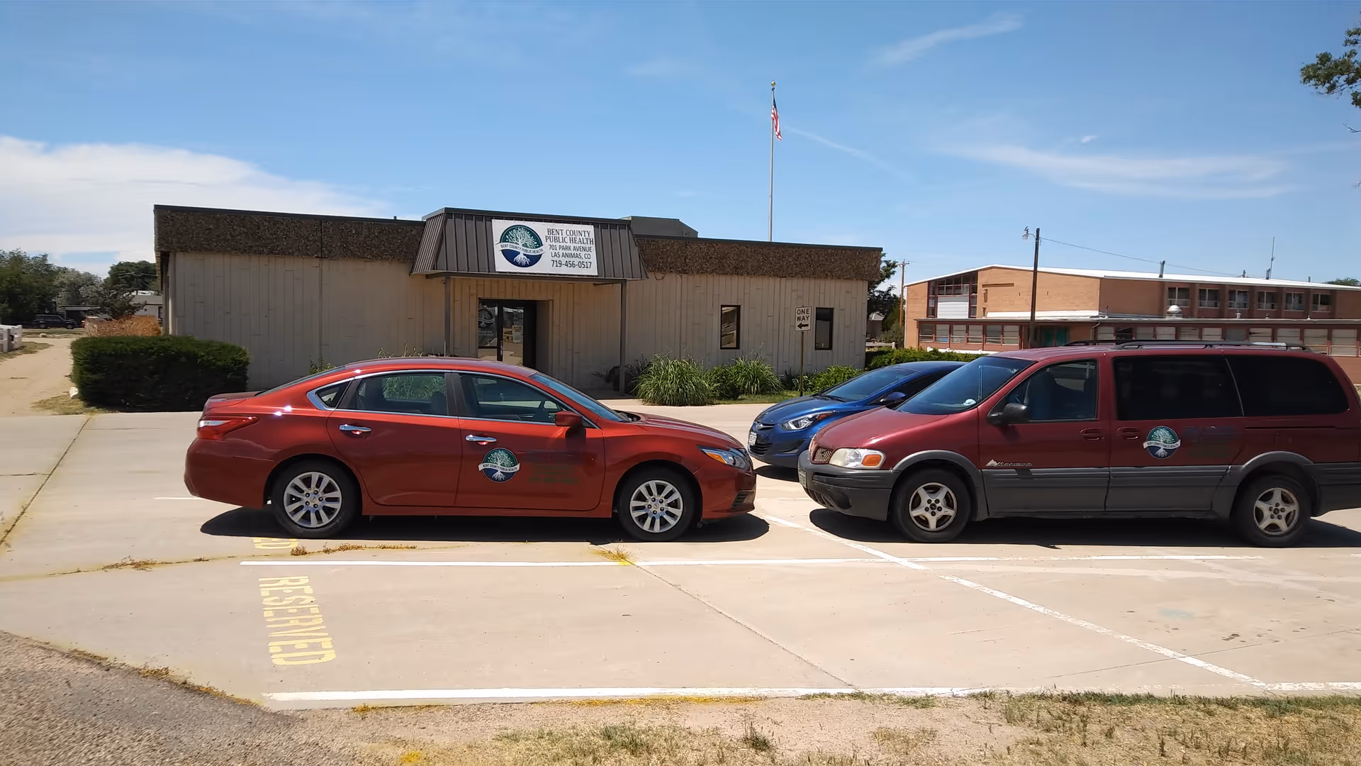 Front view of Bent County Public Health building with parked cars in the lot.