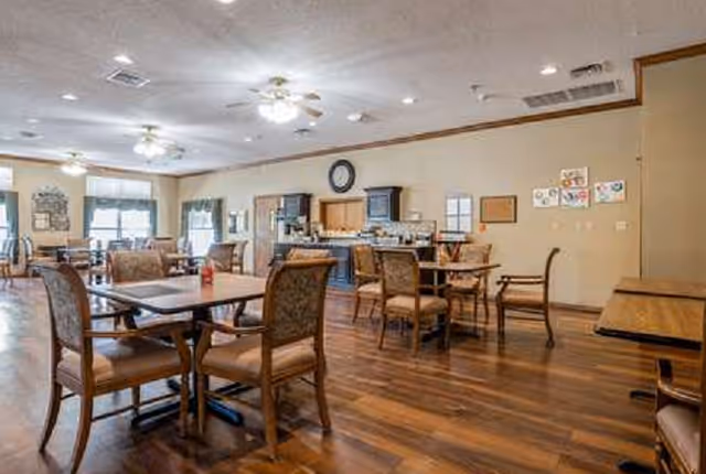 Spacious dining room with wooden tables and chairs, buffet area in back.