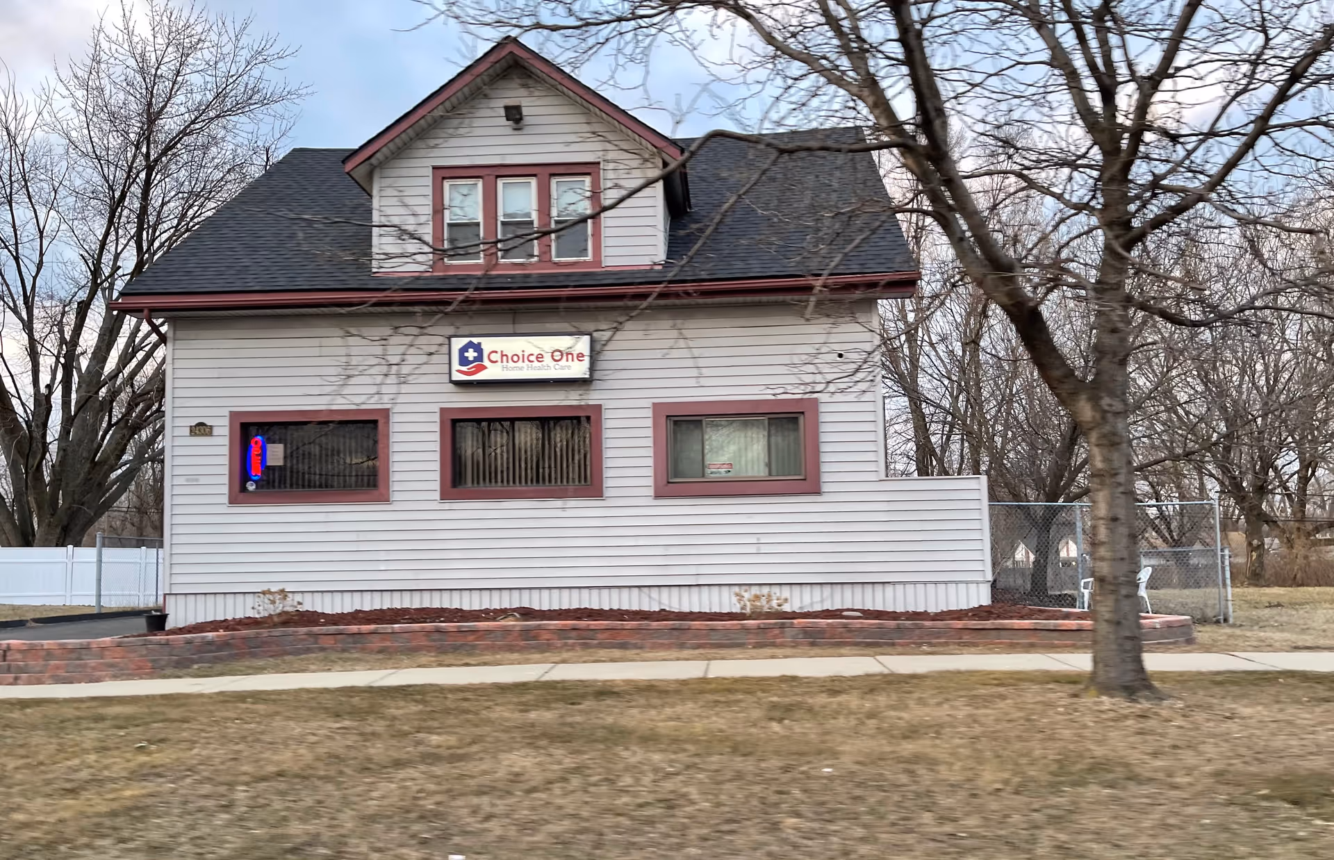 Light-colored small house with a Choice One Home Health Care sign on the front.