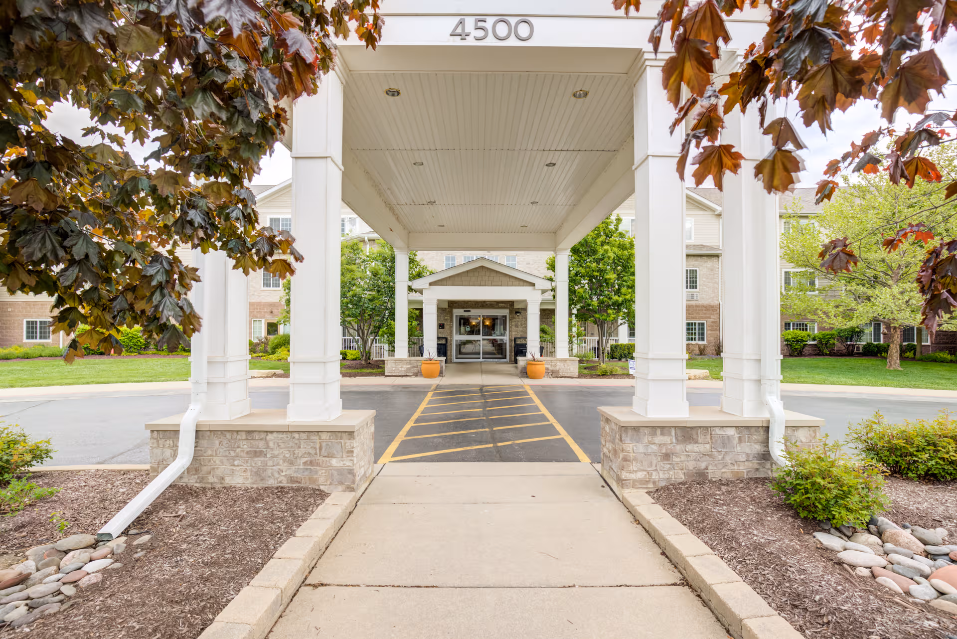 Covered entrance canopy with white columns leads to Senior Star at Elmore Place.