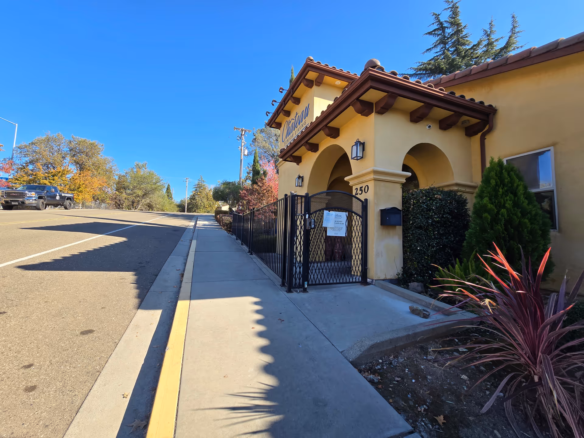 Exterior view of The Villa senior living facility entrance with a gated archway.