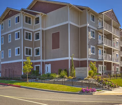 Exterior view of a multi-story Vintage at Lakewood senior living building with balconies.