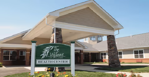 Front entrance of The Willows at Willard Health Center with sign.