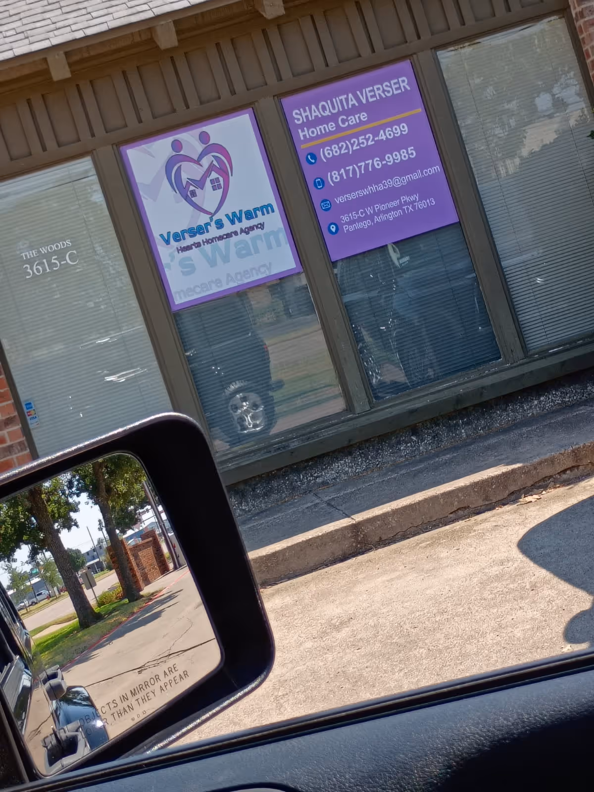 Storefront with purple signs advertising Verser's Warm Hearts Home Care Agency.