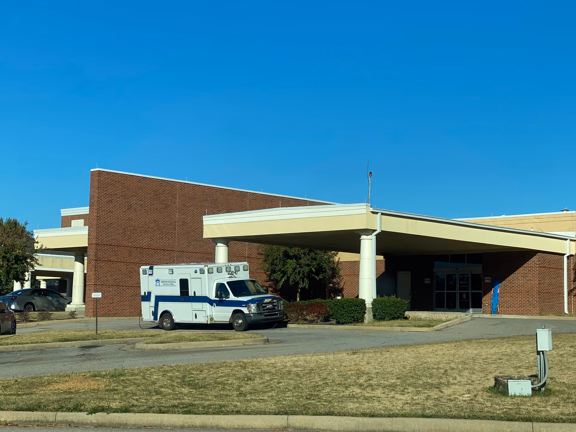 Exterior view of Johnson Regional Medical Center with an ambulance parked near the entrance.