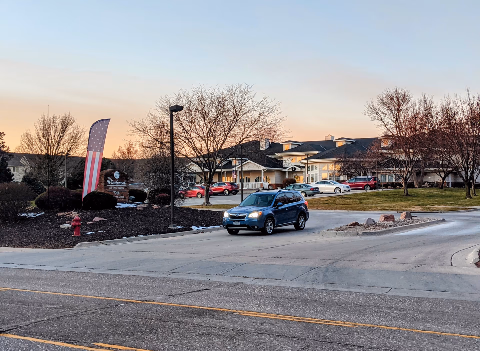 Exterior view of Bailey Pointe Assisted Living at Van Dorn with parked cars and entrance.