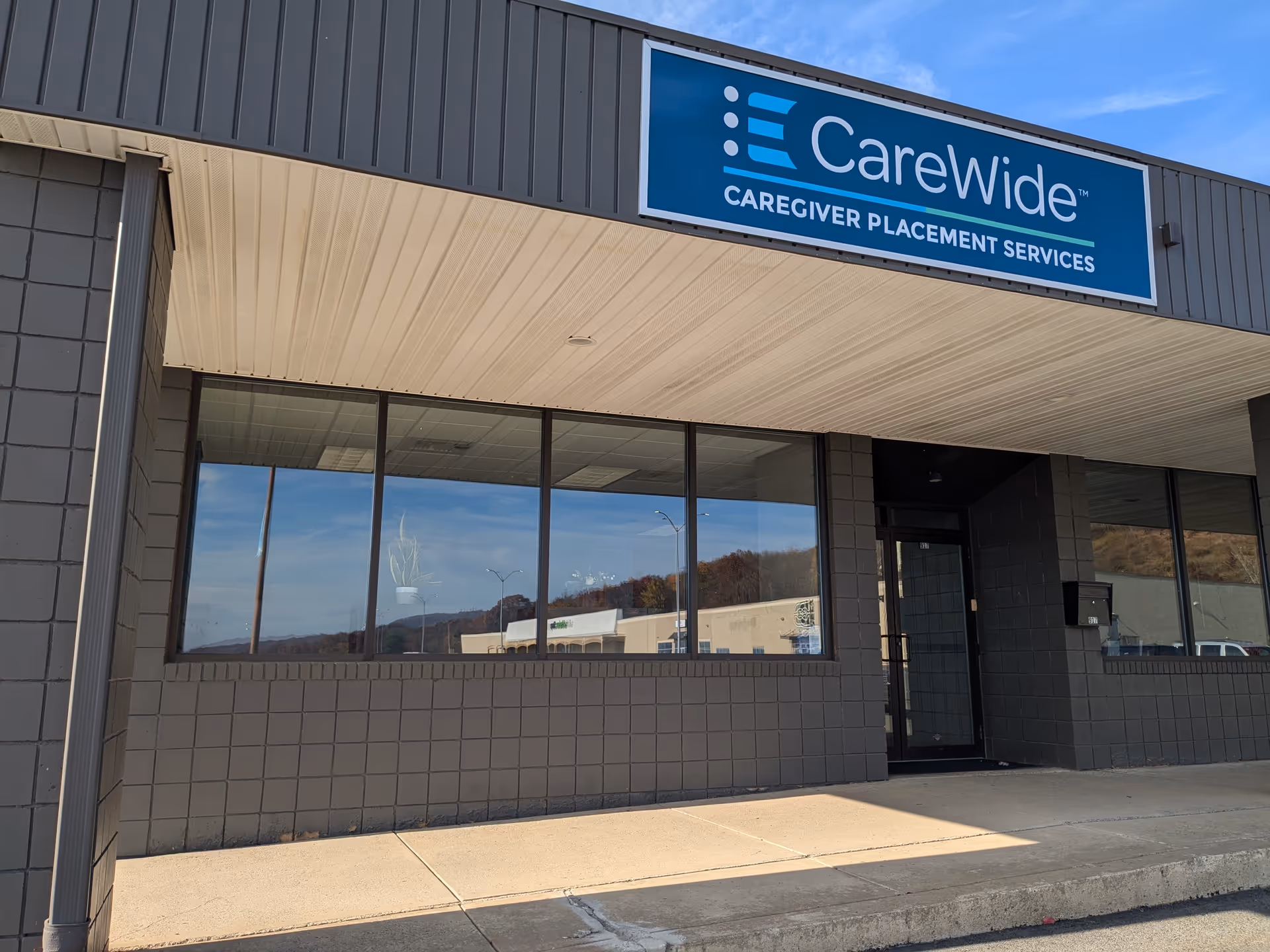 Front view of the CareWide building entrance with blue sign.