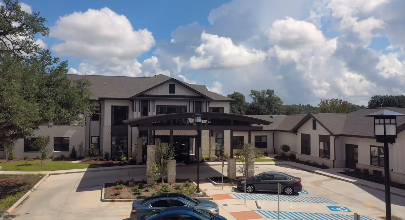 Exterior view of The Phoenix at Hammond facility with entrance, parking, and landscaping.
