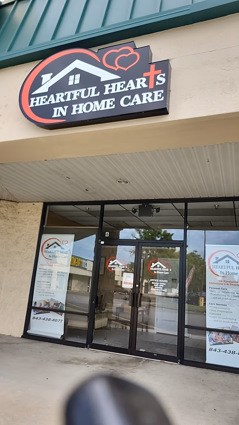 Exterior storefront for Heartful Hearts In Home Care with glass doors and signage.