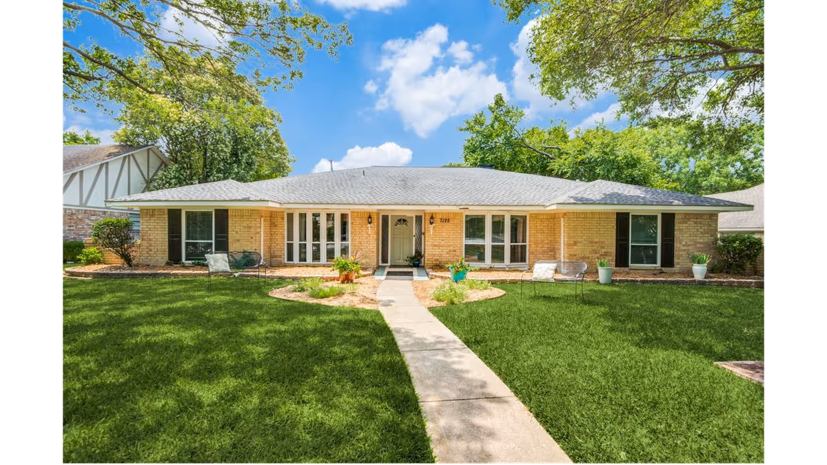 Single-story brick facility exterior with a lush front lawn and walkway.