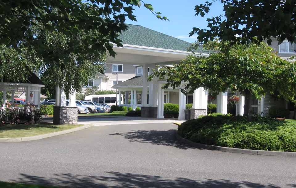 Entrance to Vineyard Park of Lynden Manor with a covered driveway and landscaped grounds.