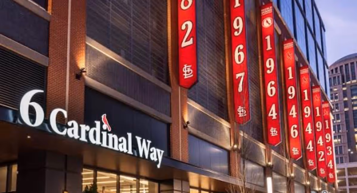 Exterior view of a building with Cardinal Way signage and vertical red banners.