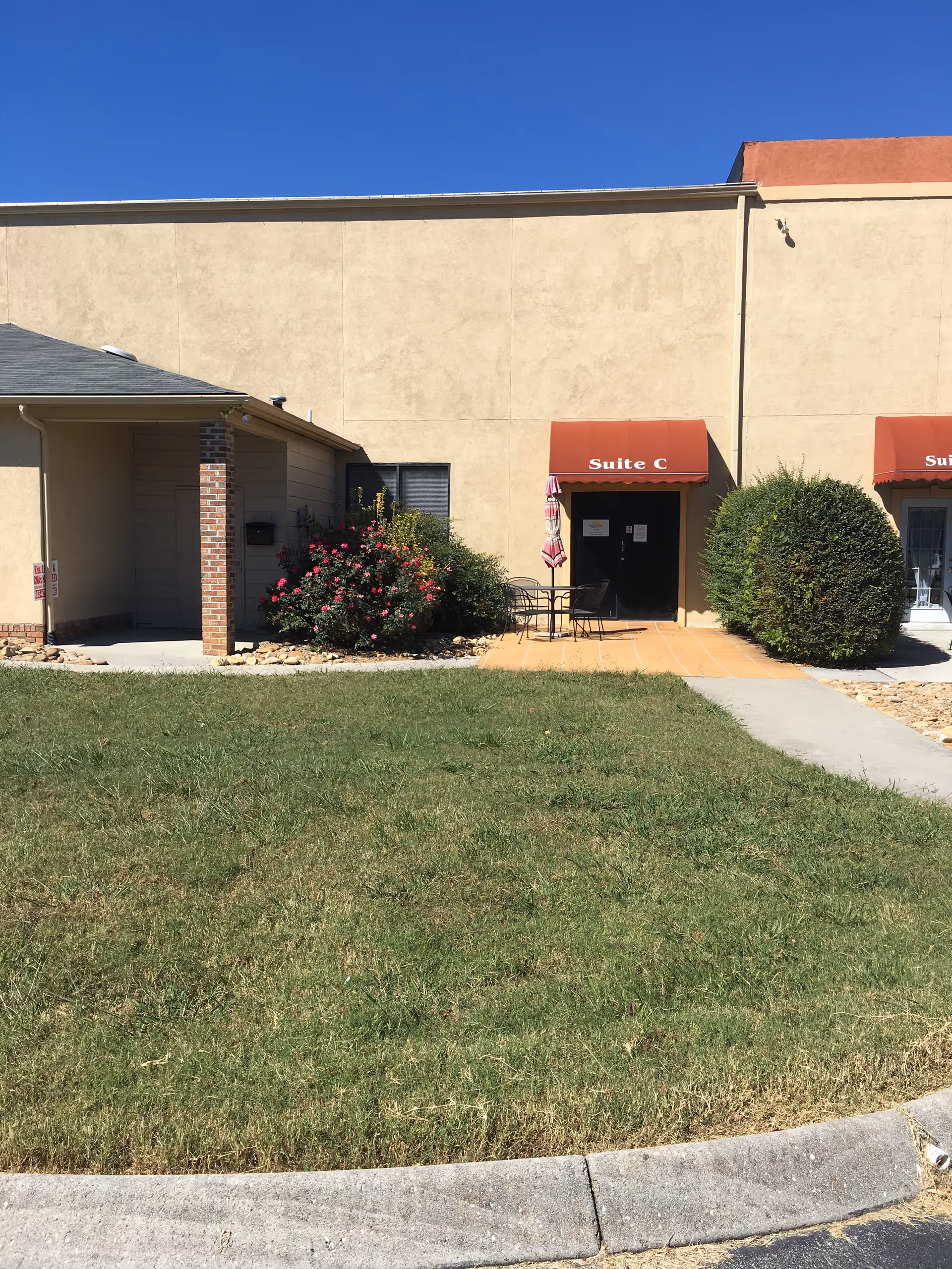 Exterior view of Beacon Home Health building with outdoor patio seating and landscaping.