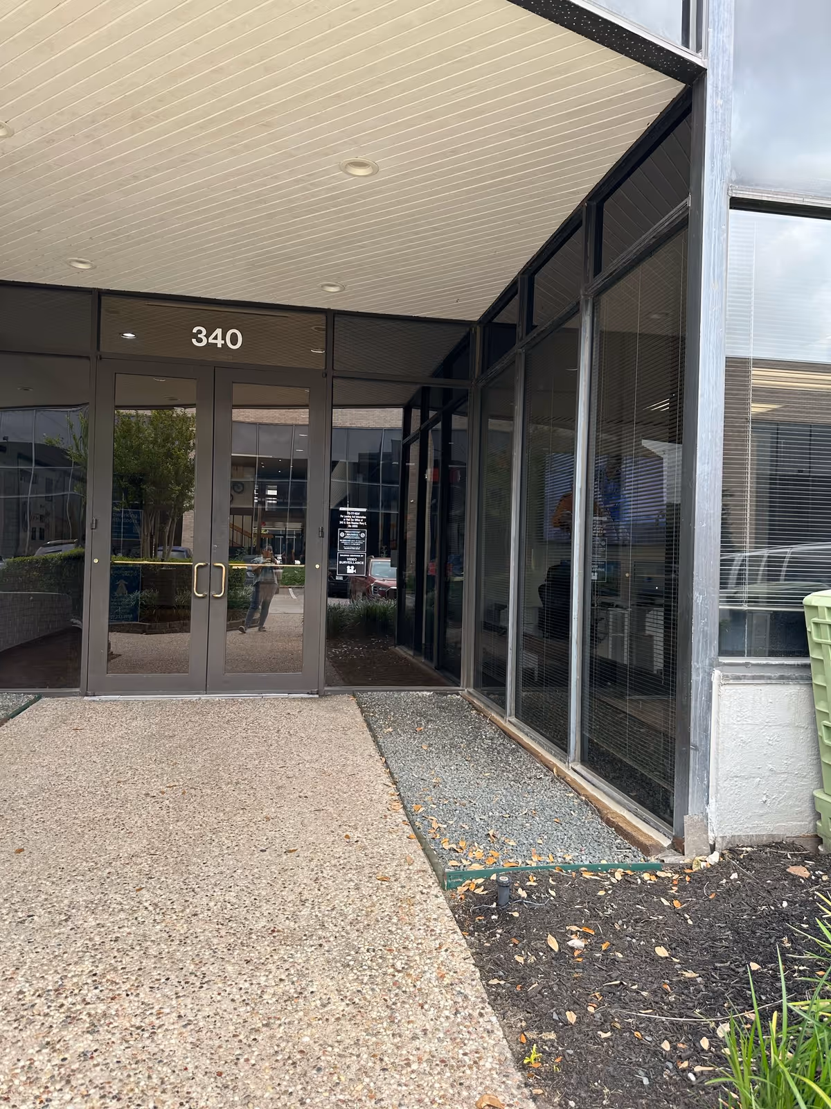 Glass doors marked 340 at Harbor Home Care entrance with a gravel path.