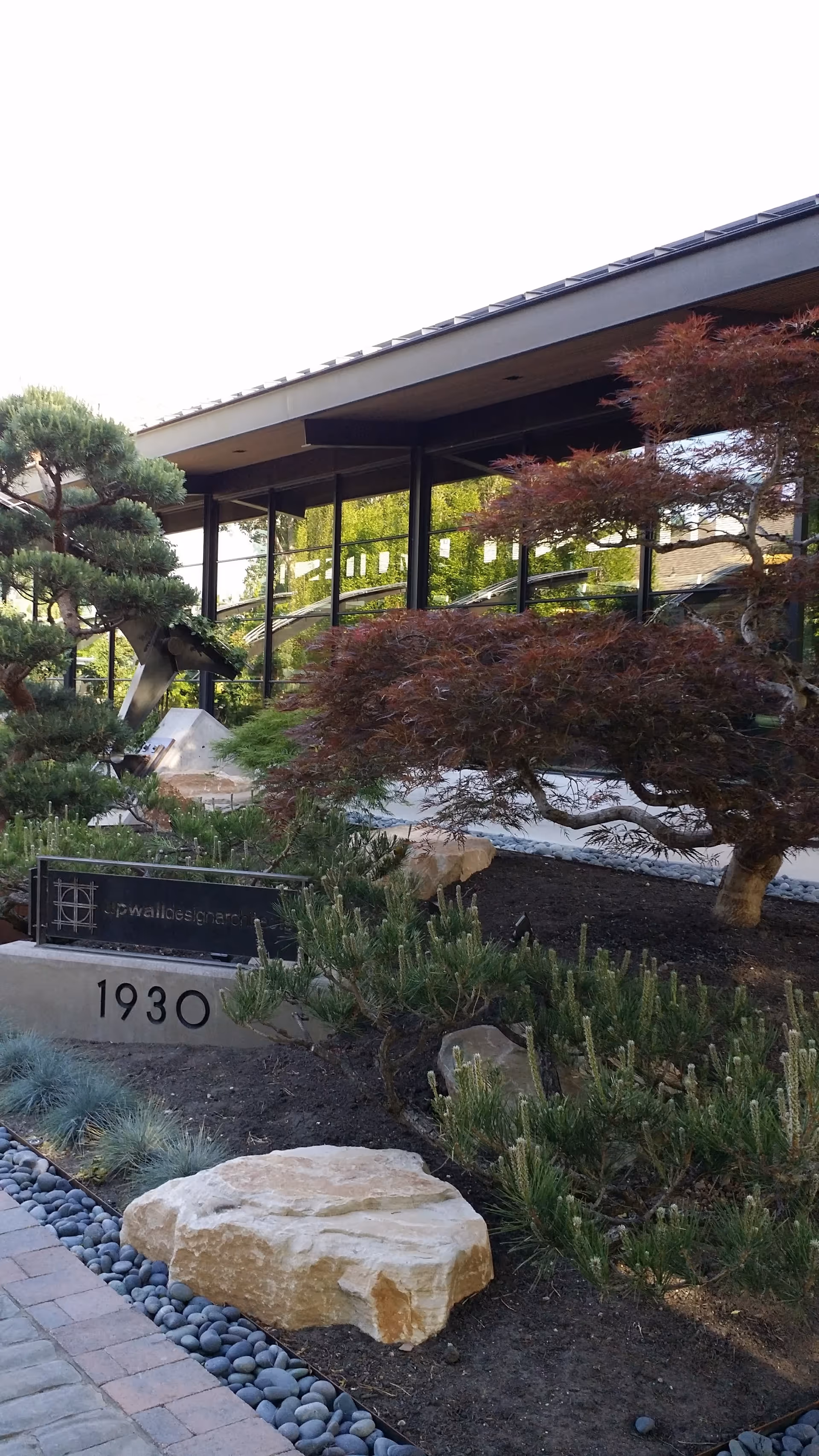 Exterior view of Solstice facility with modern glass facade and landscaped front yard.