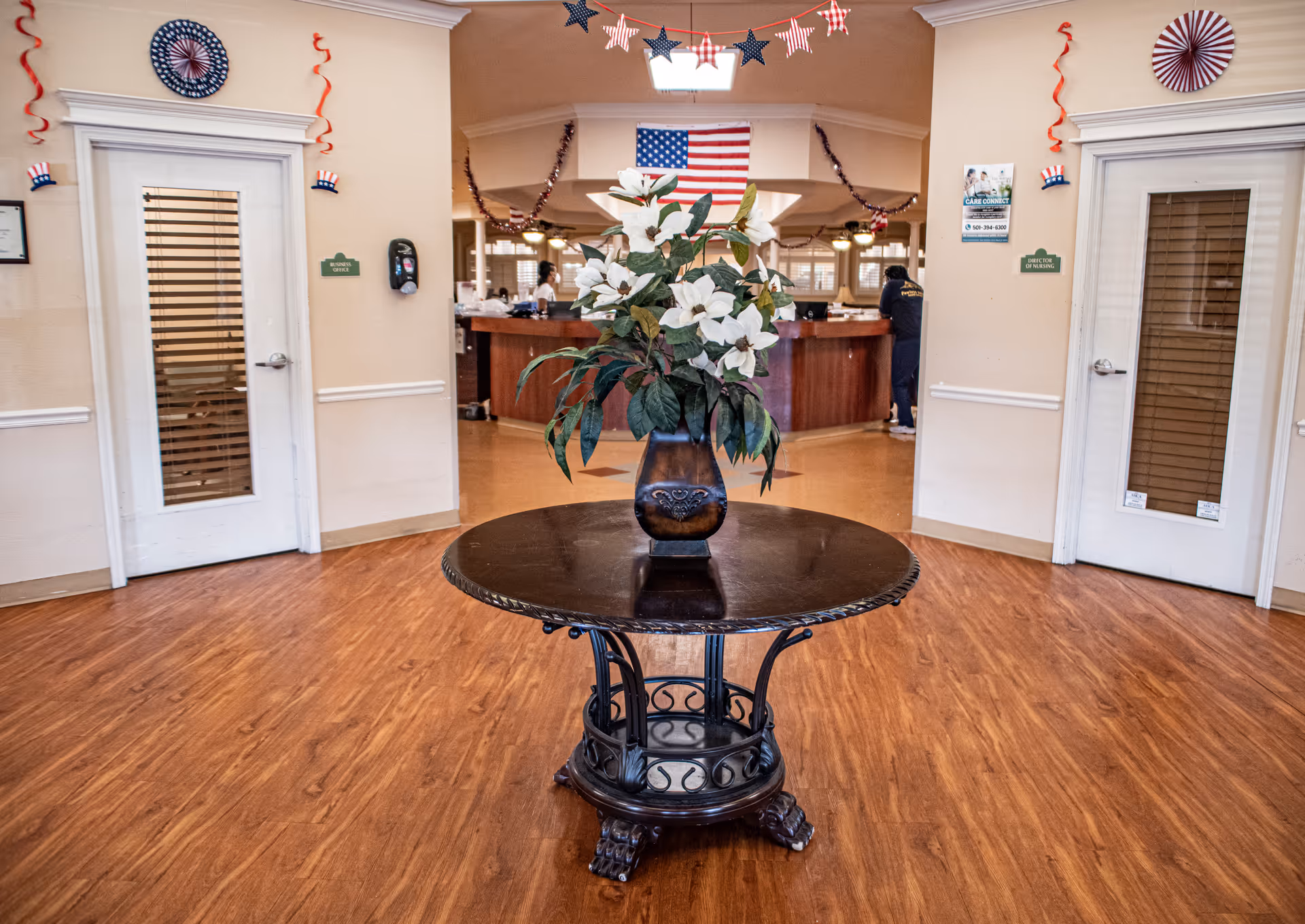 Lobby of Valley Ranch Nurse and Rehab Center with round table centerpiece and reception desk visible.