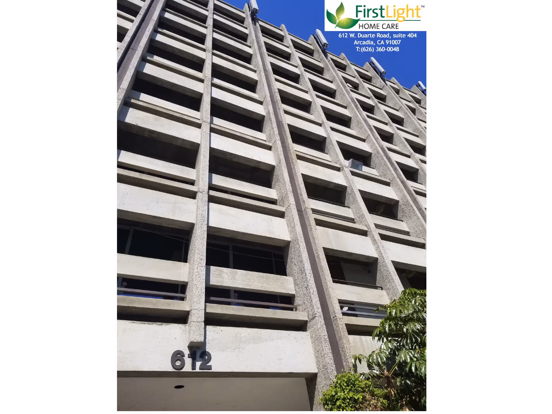 Tall multi-story concrete building with a FirstLight Home Care sign at the top.