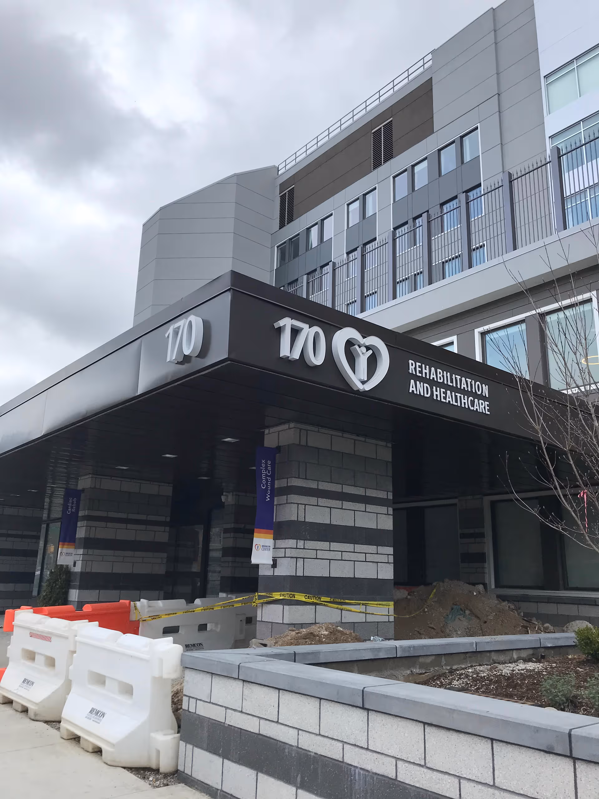 Exterior view of Brooklyn Center for Rehabilitation and Nursing entrance with construction barriers.