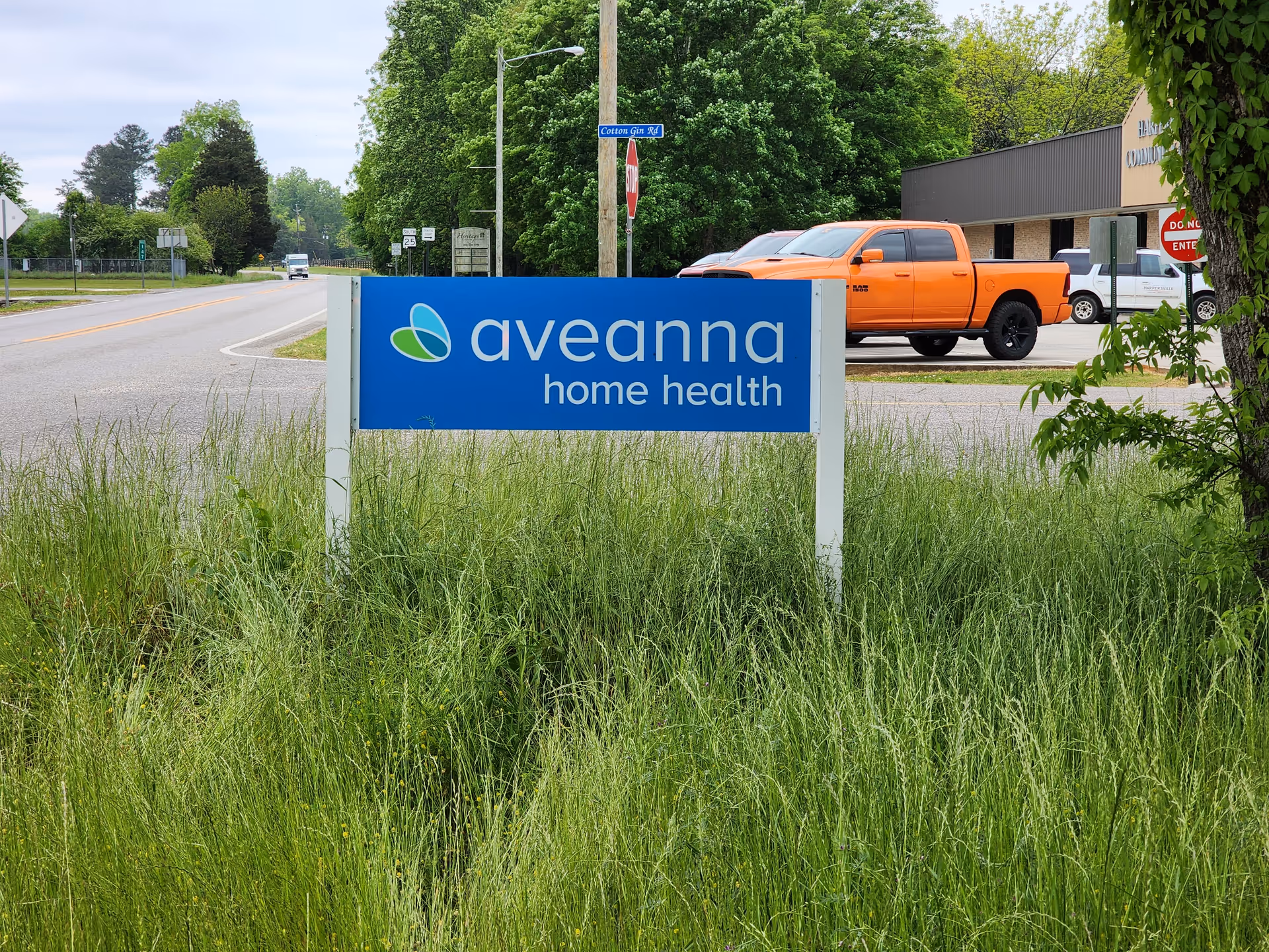 Blue Aveanna Home Health sign on grassy verge beside a road