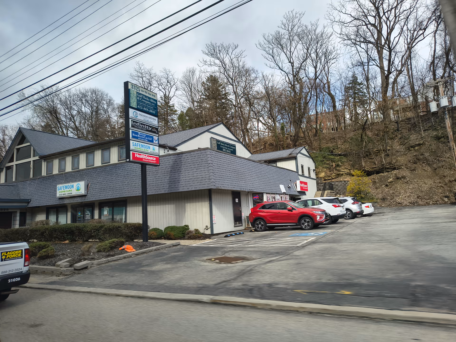 Front exterior of Safemoon Home Care LLC building with signage and parking