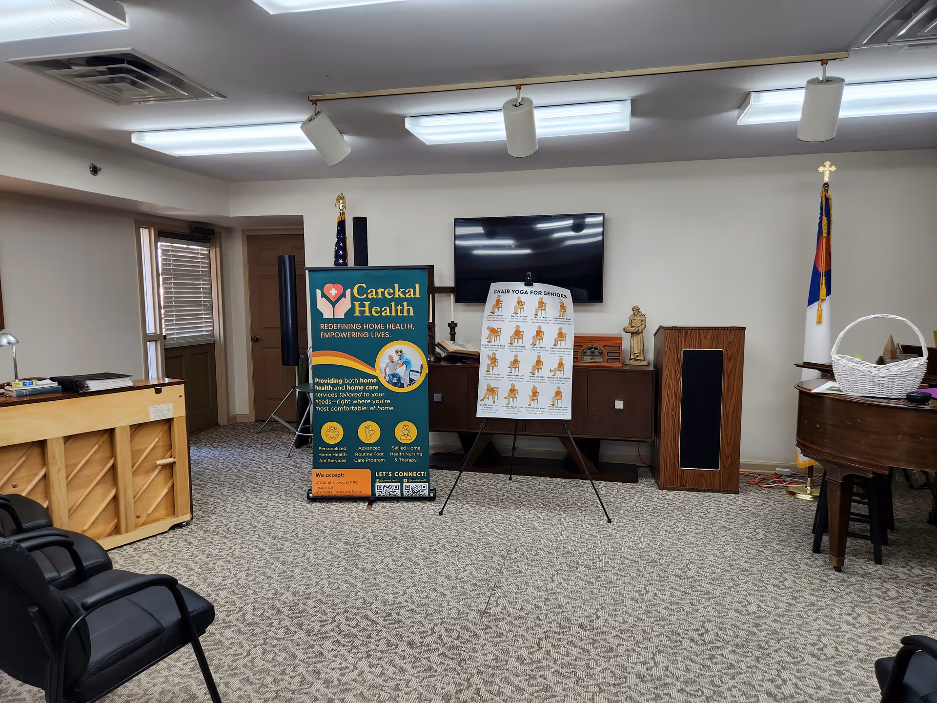 Interior room with Carekal Health banner, information boards, piano, and seating.