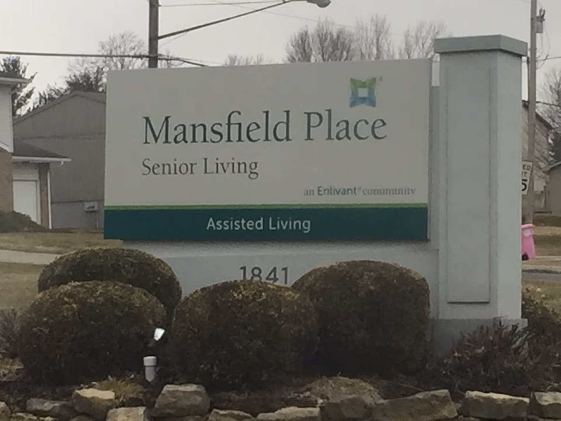 Exterior sign for Mansfield Place Senior Living with Assisted Living designation.