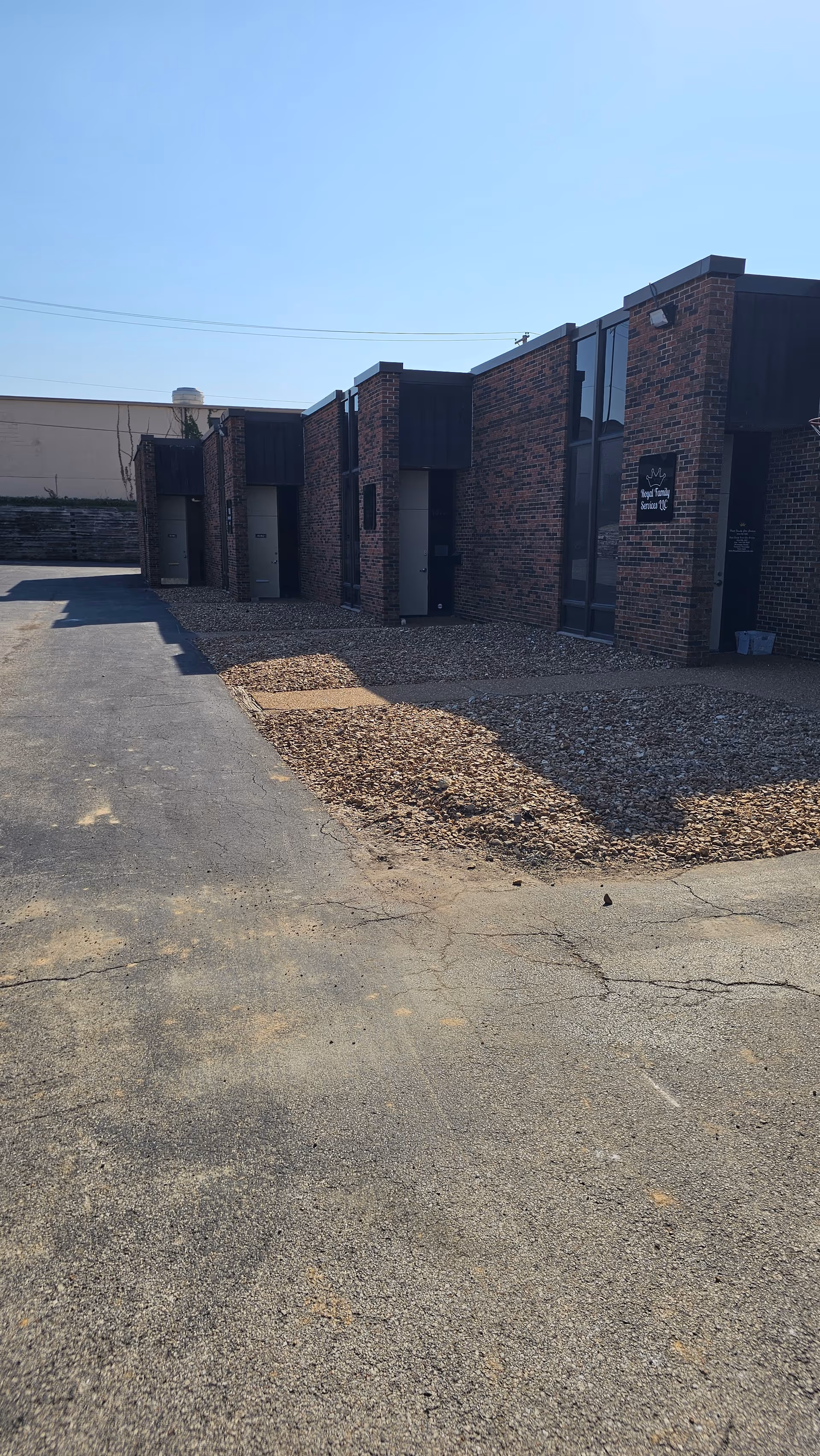 Exterior view of a brick senior living facility with multiple entrances.