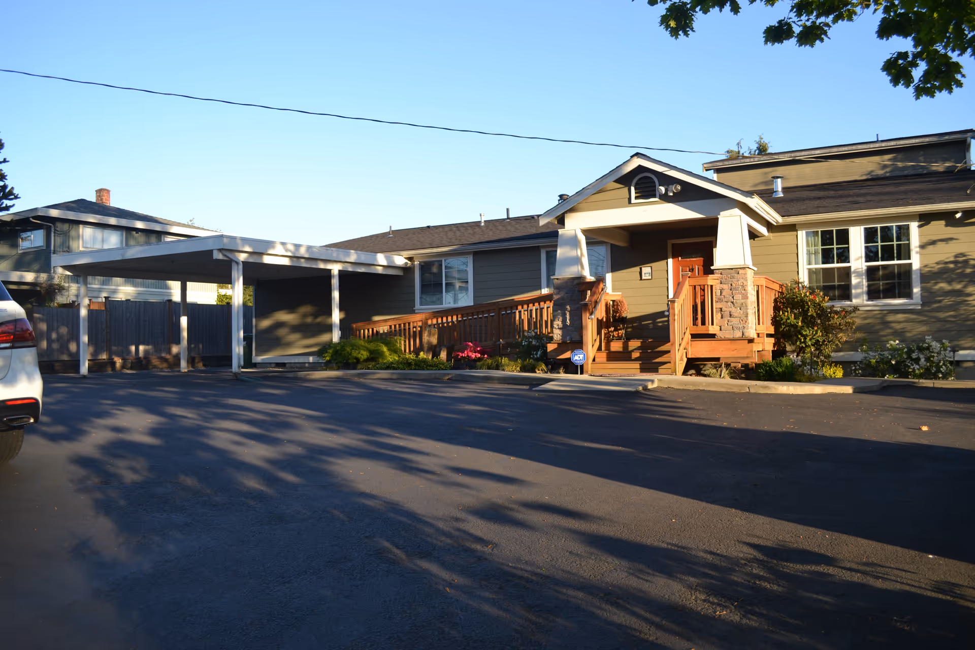 Exterior view of a Wellspring senior care facility with a wooden entry porch.