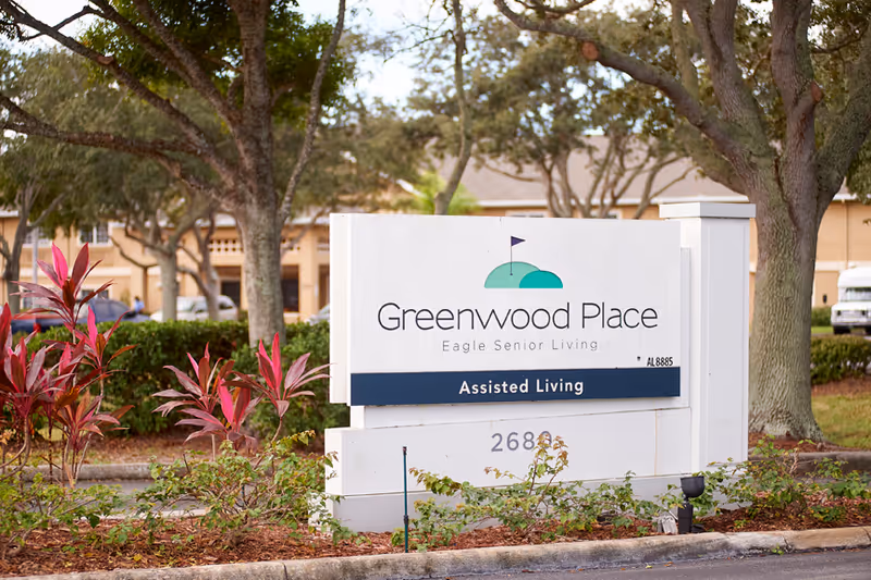 Greenwood Place sign for Eagle Senior Living outside the building with trees.