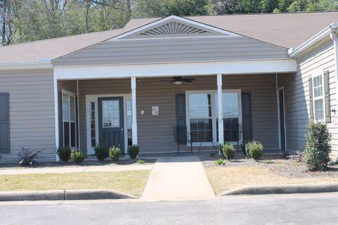 Front view of Gardens of Pelham senior living facility entrance.