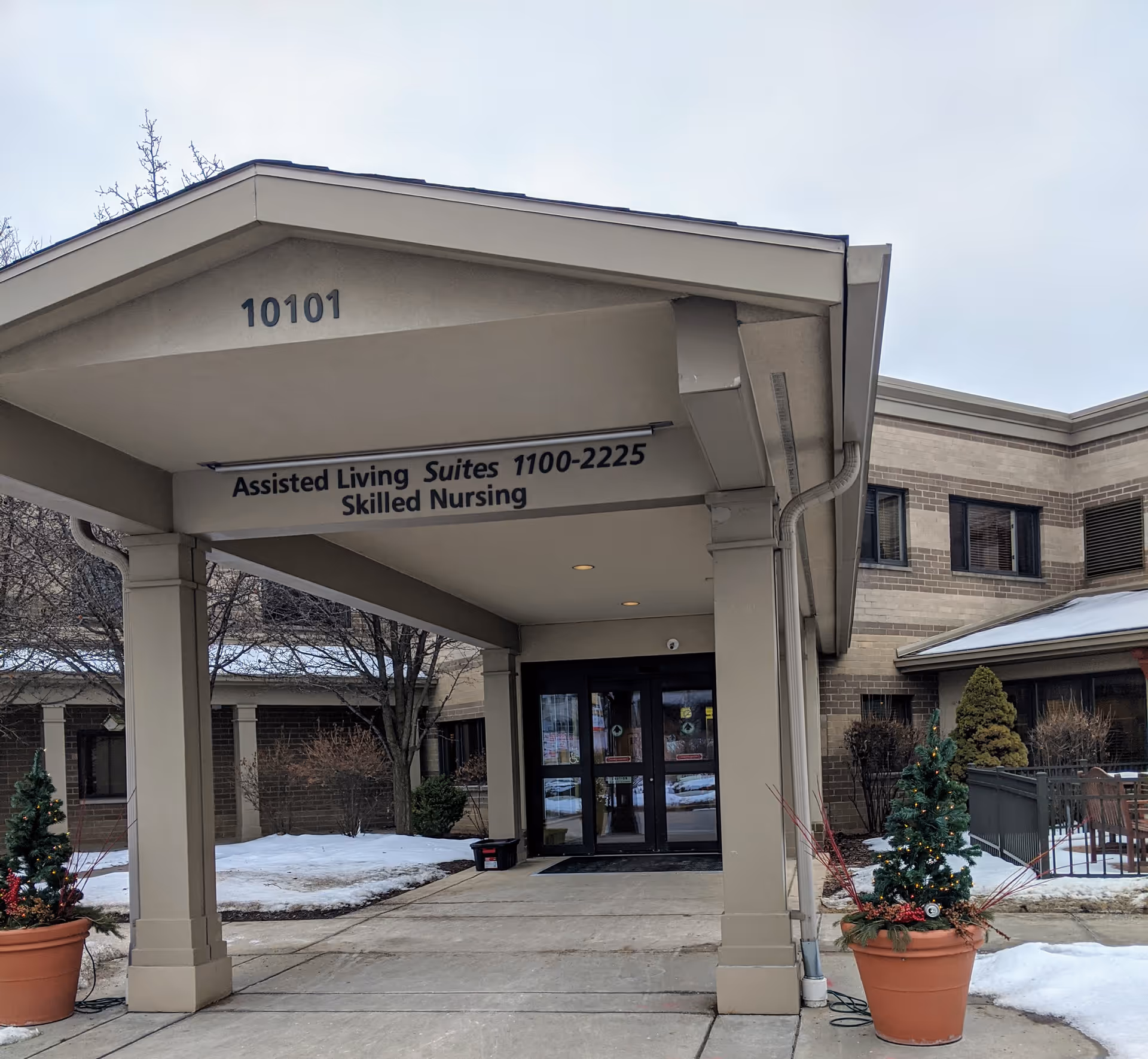 Entrance to assisted living and skilled nursing with a covered canopy and signage