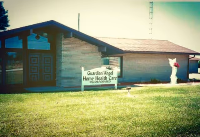 Exterior view of Guardian Angel Home Health Care facility with a sign in front