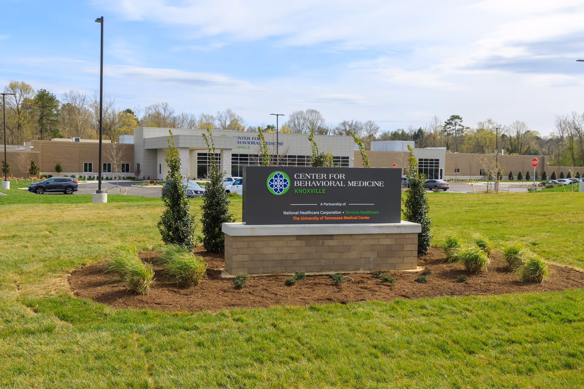 Exterior view of a medical center with a sign reading Knoxville Center for Behavioral Medicine.