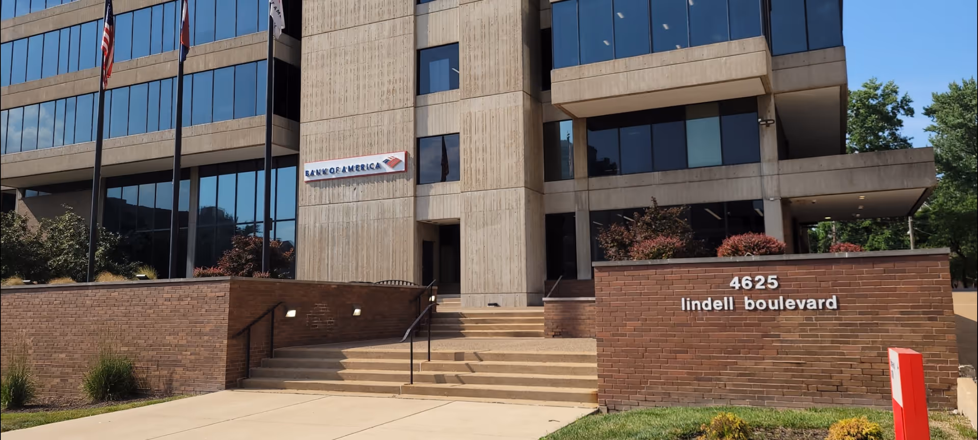 Exterior view of a modern office building with Bank of America sign and steps.