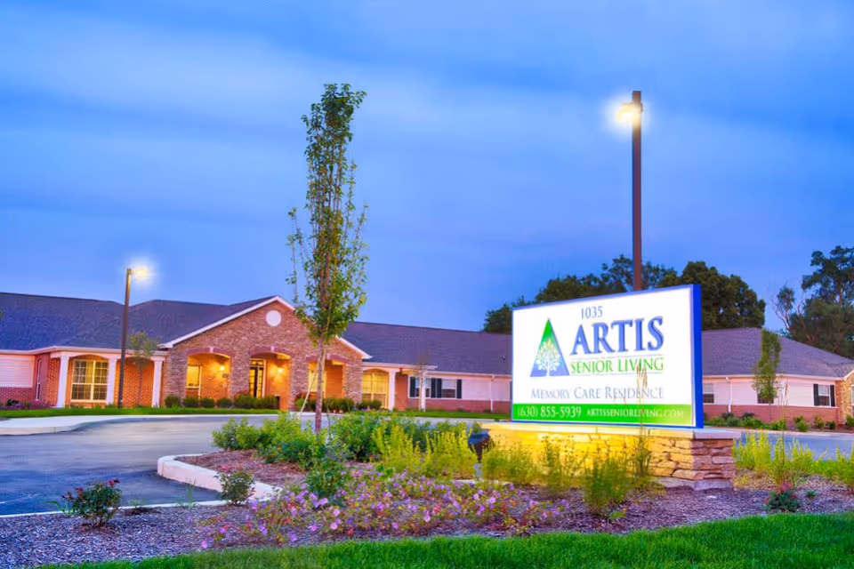 Exterior view of Artis Senior Living with illuminated front sign