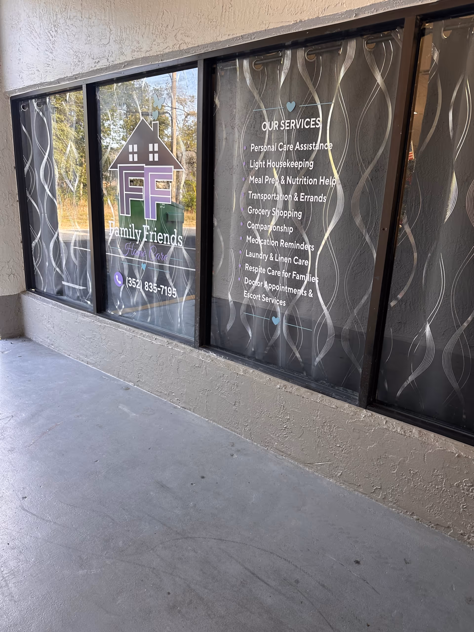 Exterior view of a facility with glass windows displaying Family Friends Home Care logo and services.
