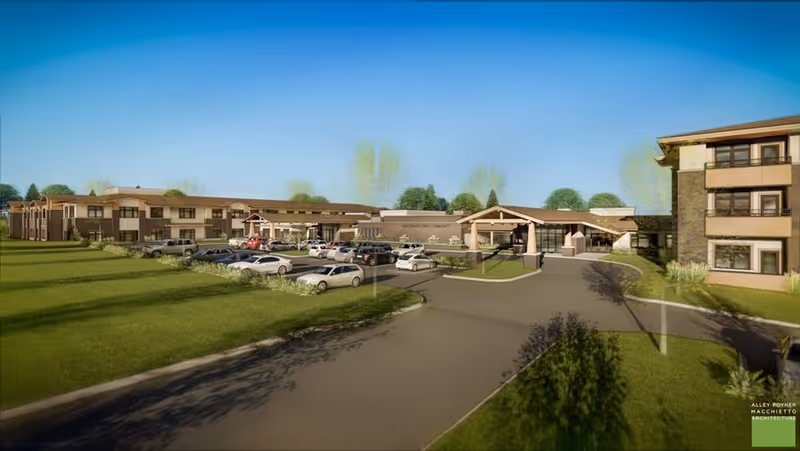 Exterior view of The Knolls Senior Living facility showing the driveway and parking area.
